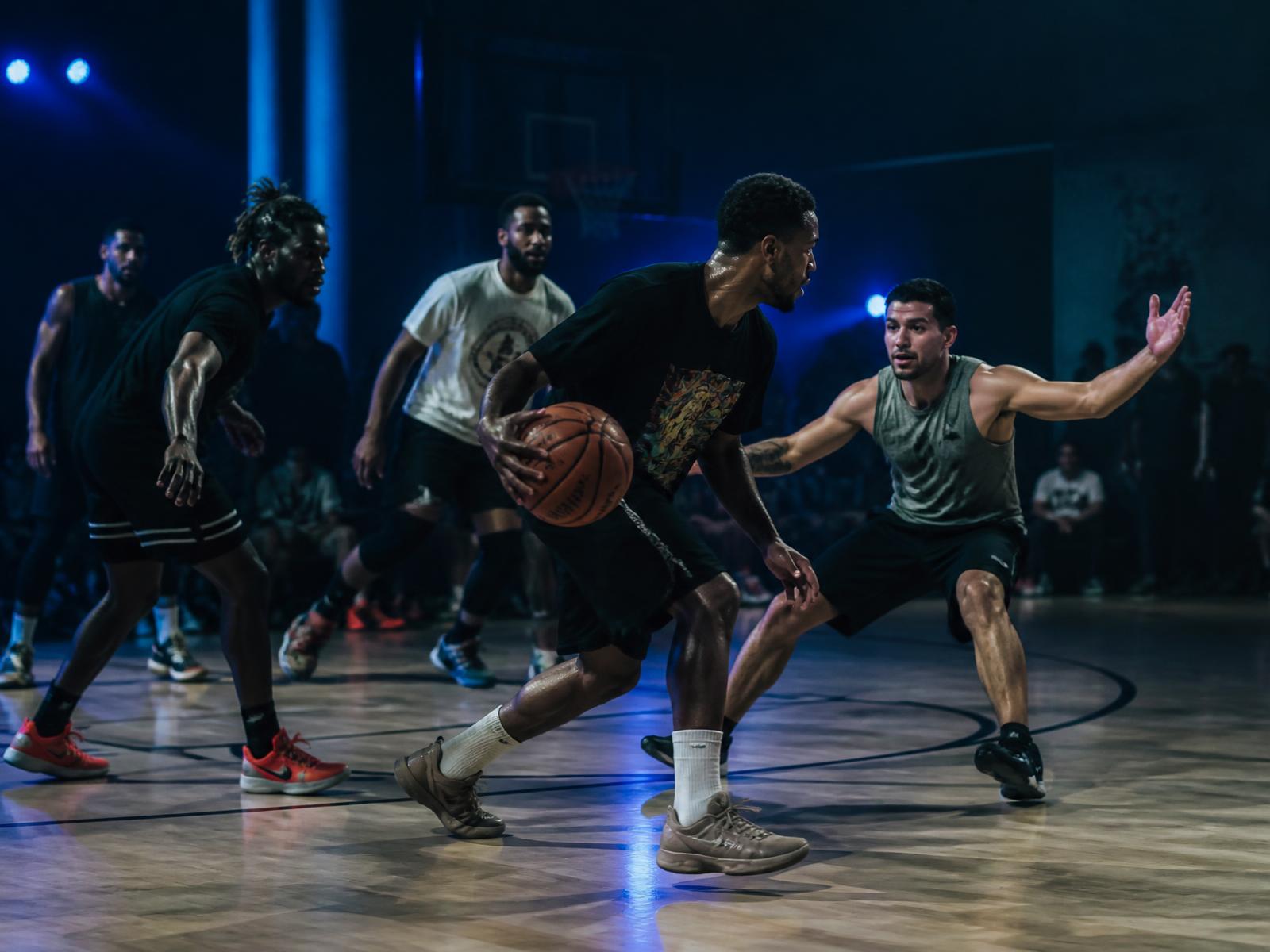 Players competing in an indoor pickup basketball run